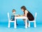 Mother and son play chess. Family and education concept