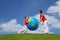 Mother with son play an inflatable globe