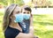 Mother with son at the playground  in face masks. People wears a protective medical masks during an epidemic coronary virus or flu