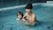 Mother and son in the pool. Young mother teaches her 3-year-old son to swim