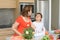 Mother and son preparing lunch and joking with a piece of carrot in the mouth