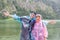 Mother and son with raincoats at coast of German Konigssee