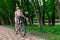 Mother and son ride a Bicycle, mother carries a child in a child`s chair on a Bicycle in the Park in the summer