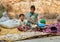 Mother and son selling garlic and onions at street market of Puttaparthi.