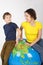 Mother and son sitting on big inflatable globe