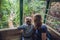 Mother and son in ski lift cabin in summer Over the waterfall. Passengers on a cable car