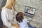 Mother with son talking to doctor online from home. Parent and little boy having video call with pediatrician on laptop