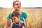 Mother son together portrait rural wheat field during harvesting as farmer family lifestyle