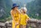 Mother and son tourists on the lake Tam Coc and pagoda of Hang Mua temple, Ninh Binh, Viet nam. It& x27;s is UNESCO World