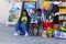 A mother and son using their mobile phone and tablet as they sit outside their small shop in Albuferia in Portugal