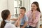 Mother and son visiting pediatrician. Doctor examining patient`s throat in hospital