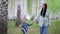 Mother and son walk in a birch grove on a spring day