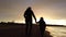 Mother and son walking on Tsilivi beach at dusk