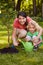 Mother and son watering tree