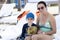 Mother with Son Wearing Good Sun Protection Clothes Sit on a Chair at Punta Mita, Nayarit, Mexico, on the Beach while the Boy