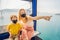 Mother and son wearing a hygiene protective mask over her face while ride a cable car. Healthcare and sickness