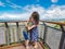 Mother and sons cuddling while sightseeing at the Forest Sky Pier at Sealy Lookout in Coffs Harbour, Australia