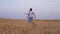 Mother and sons walking in wheat field