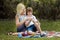 Mother and Special Child Resting on a Lawn