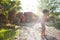 Mother sprays a child with a hose in the courtyard of the house, Boy drenched in water on a hot sunny day