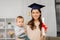 Mother student with baby boy and diploma at home