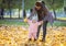 Mother supporting baby daughter and helping her make first steps.