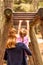 Mother Supporting daughter in the playground with climbing and hanging on a ladder