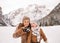 Mother and surprised child checking photos in winter outdoors