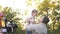 Mother taking photo of her husband and daughter with camera in the autumn park. Family, technology and people concept