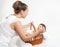 Mother talk with baby in basket on white towel, family concept