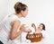 Mother talk with baby in basket on white towel, family concept