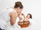 Mother talk with baby in basket on white towel, family concept