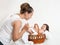 Mother talk with baby in basket on white towel, family concept