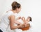 Mother talk with baby in basket on white towel, family concept