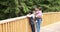 Mother talking with children standing on wooden bridge