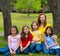 Mother teacher with daughter pupils in playground park