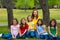 Mother teacher with daughter pupils in playground park