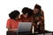 A mother or teacher looking at a computer with 2 teenagers