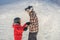 Mother teaches son snowboarding. Activities for children in winter. Children`s winter sport. Lifestyle