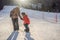 Mother teaches son snowboarding. Activities for children in winter. Children`s winter sport. Lifestyle