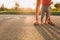 Mother teaching baby daughter first steps outside in the sunset