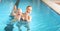 Mother teaching baby swimming pool