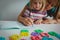 Mother teaching daughter how to write letters