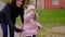 Mother teaching daughter to ride a bicycle