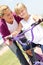 Mother teaching girl ride bicycle