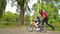 Mother Teaching her Son to Ride a Bike in Park