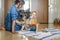 Mother teaching little kid counting on multi colored childish wooden ecological abacus on floor