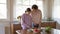 Mother and teen daughter cooking together at kitchen