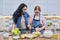 Mother and teenage daughter cooking at home in the kitchen.