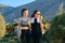 Mother and teenage daughter eating apples after jogging on sunset mountain road